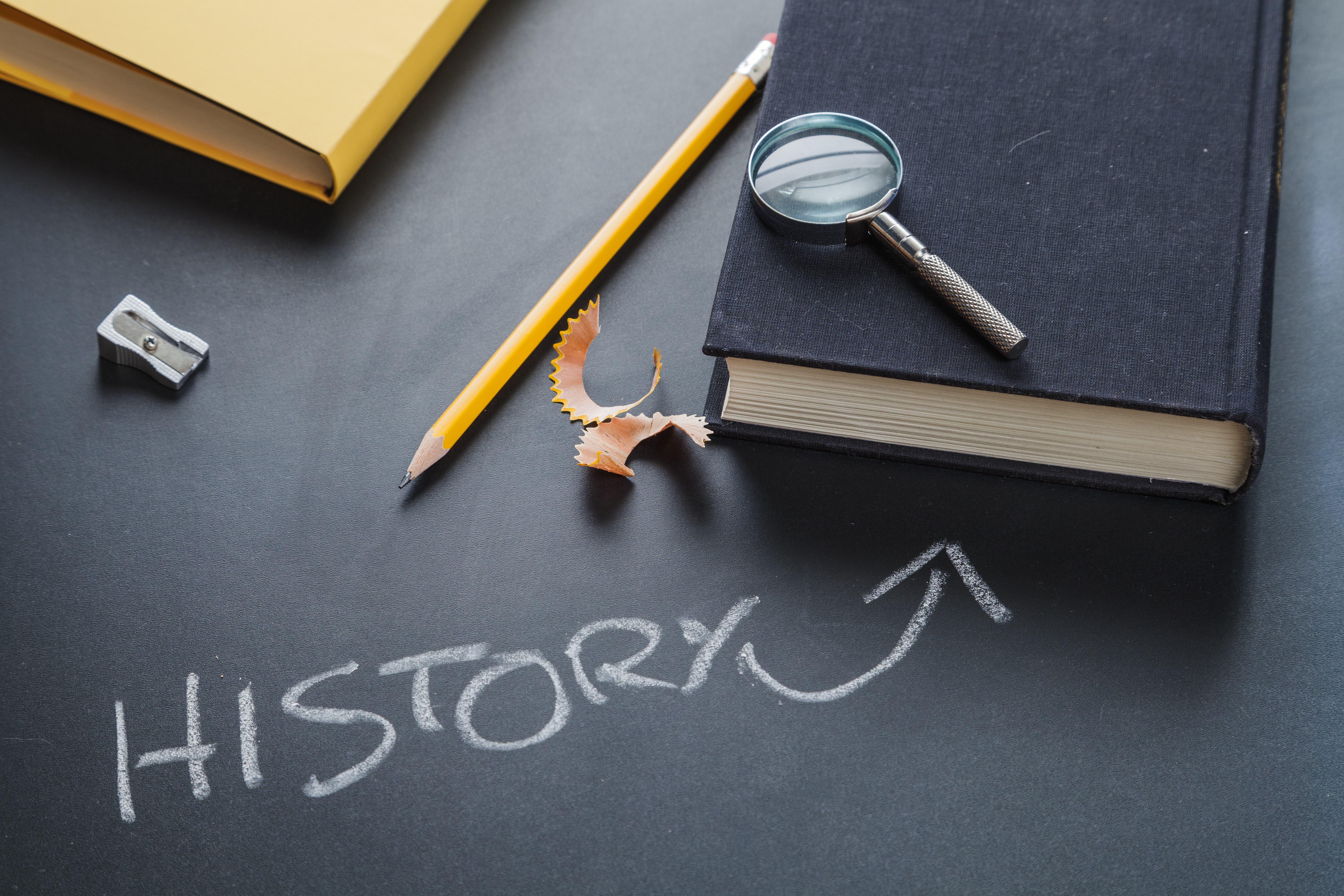 Student reviewing archival history documents at a reading room table